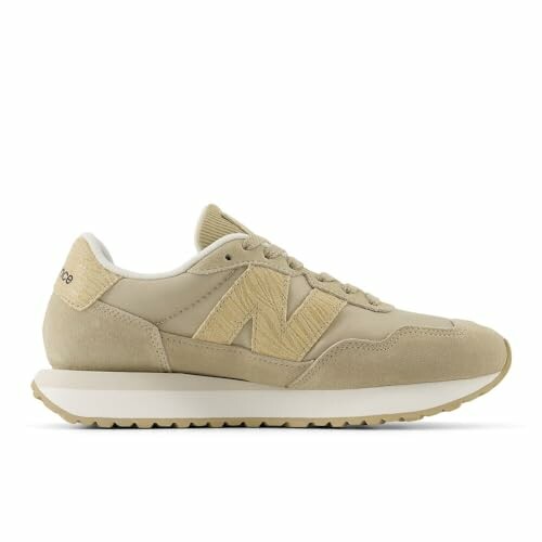 Beige sneaker with white sole, side view.