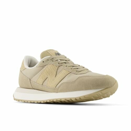 Beige sneaker with white sole, side view.