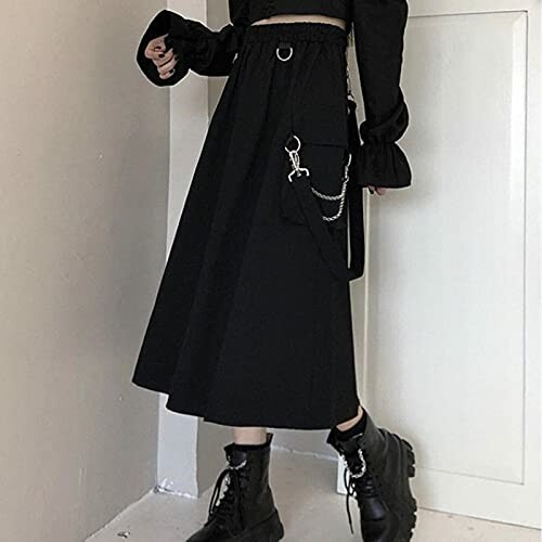 Woman wearing a black gothic-style midi skirt with boots.