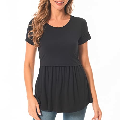 Woman wearing a black peplum top with short sleeves.