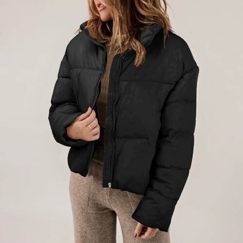 Woman wearing black puffer jacket and brown pants