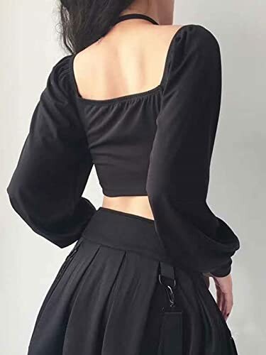 Back view of a person wearing a black square-neck top with long sleeves and a skirt.