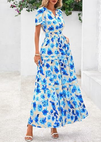 Woman wearing a blue floral maxi dress with short sleeves.
