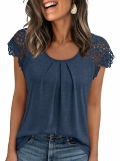 Woman wearing a blue top with lace sleeves and blue jeans.
