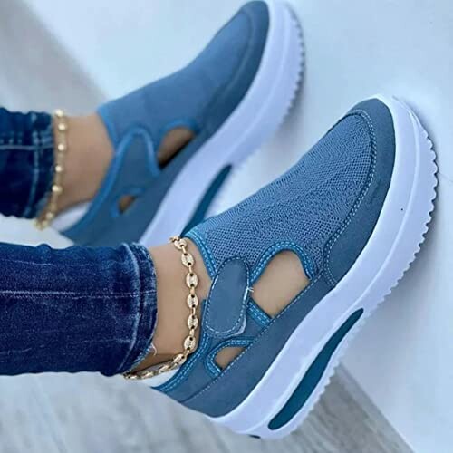 Blue slip-on sneakers with white soles and gold ankle bracelets.