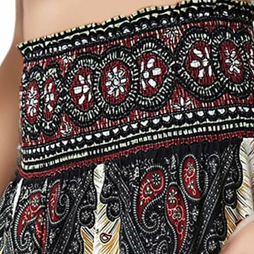 Close-up of bohemian patterned fabric with red, black, and white designs.