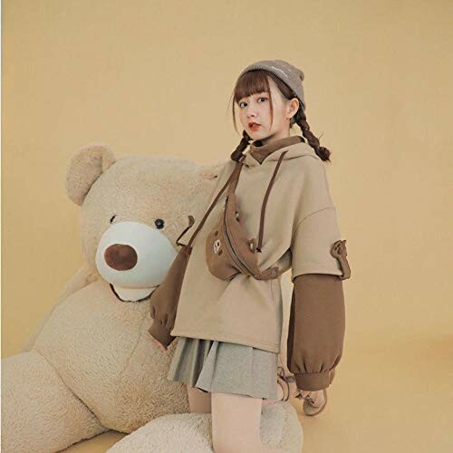 Girl in stylish outfit posing with large teddy bear