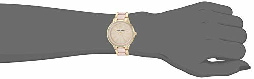 Gold and pink wristwatch on a mannequin hand.