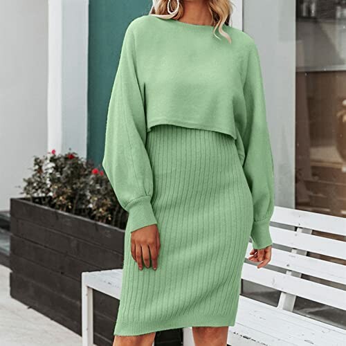 Woman wearing a green knit dress with long sleeves.