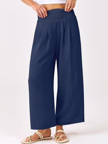 Person wearing navy wide-leg pants and sandals.