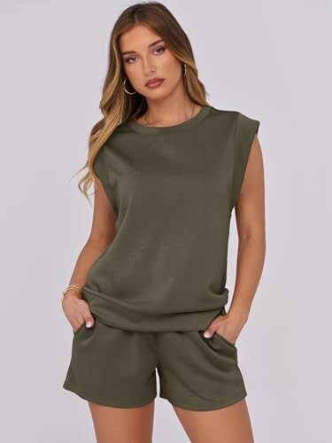 Woman wearing olive sleeveless top and shorts.