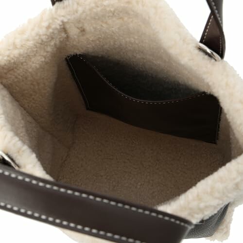 Interior view of an open sheepskin-lined bag with leather strap.