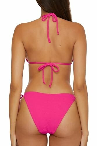 Back view of a person wearing a pink bikini.