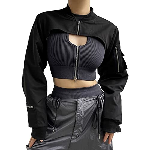 Woman wearing a black crop jacket with zipper details and a cutout design.