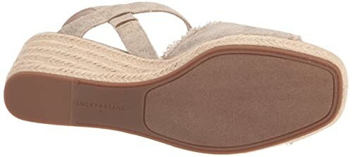 Bottom view of a wedge heel sandal with a textured sole.