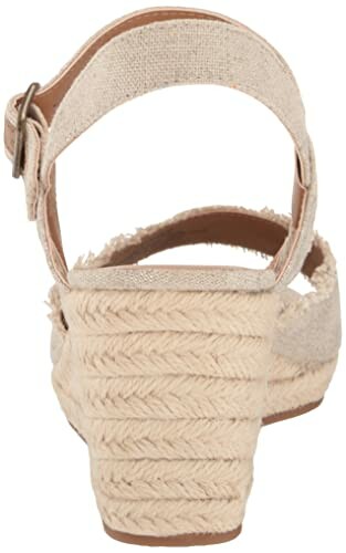 Back view of a beige wedge sandal with ankle strap.