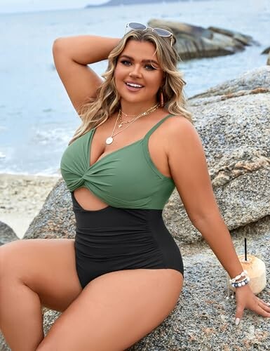 Woman in a swimsuit sitting on rocks at the beach