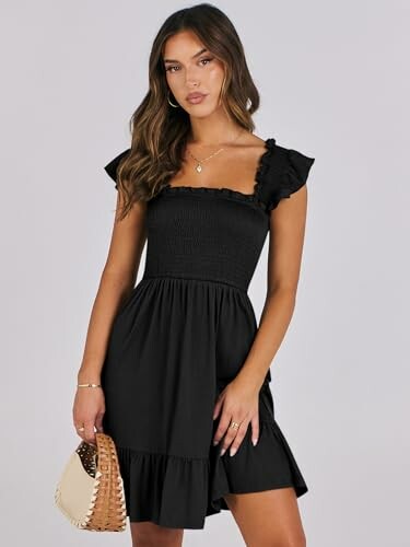 Woman in black dress holding a handbag