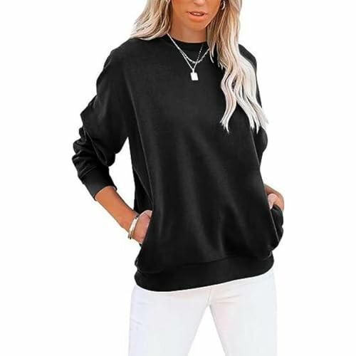 Woman wearing a black sweatshirt with white pants