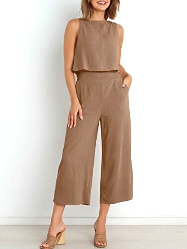 Woman wearing a brown sleeveless jumpsuit with wide-leg pants.