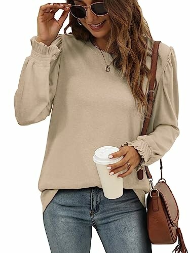 Woman in beige top with coffee cup and brown bag