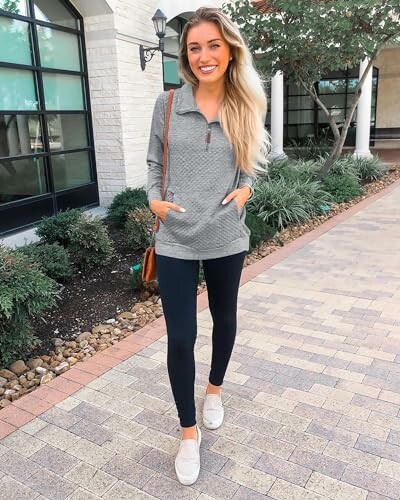 Woman in casual outfit walking on a paved path.