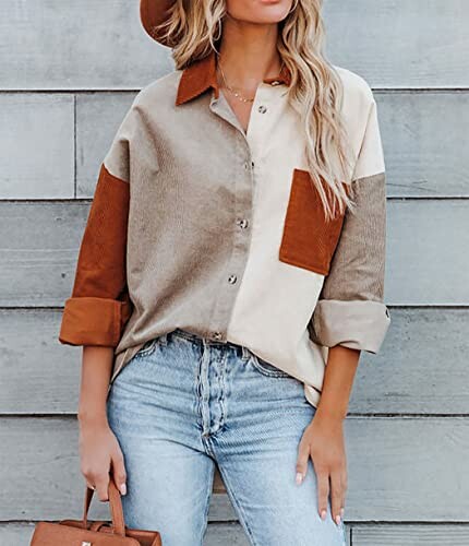 Woman wearing a colorblock shirt with jeans and a hat