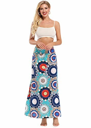 Woman wearing a colorful patterned maxi skirt and white crop top.