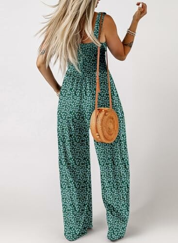 Woman wearing a green floral jumpsuit with a round woven bag