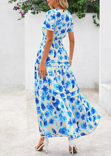 Woman wearing a blue floral maxi dress with white high heels.