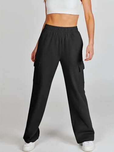 Woman wearing black cargo pants and a white crop top.