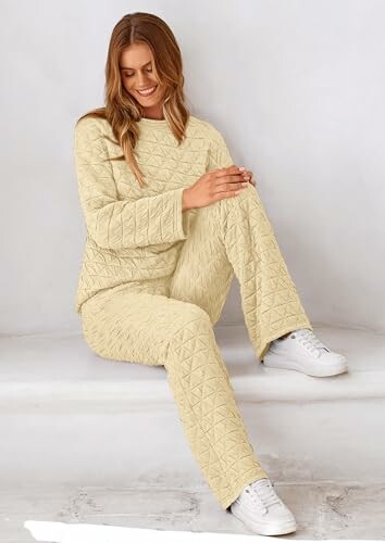 Woman sitting in quilted loungewear set with sneakers.