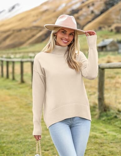 Woman in beige sweater and hat outdoors