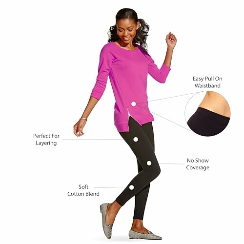 Woman wearing black leggings and a pink top, highlighting features like waistband and fabric.