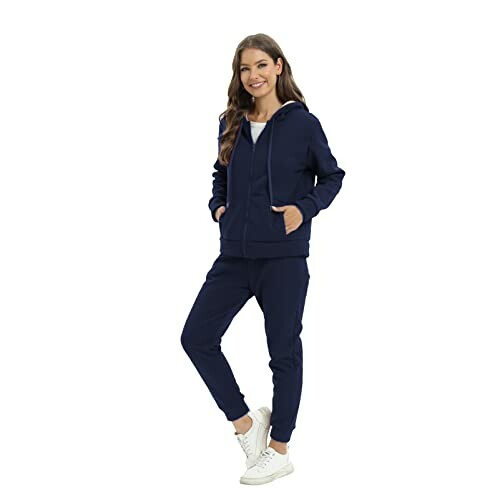 Woman wearing navy tracksuit and white sneakers