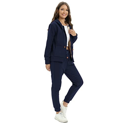 Woman wearing a navy tracksuit with white sneakers