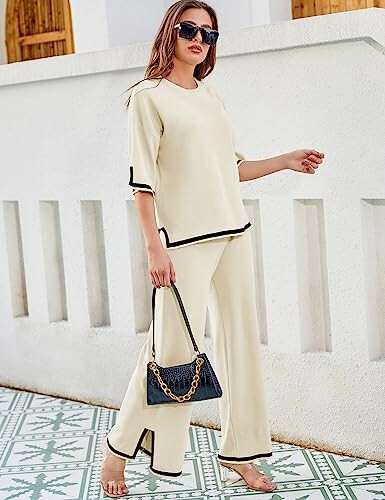 Woman in beige outfit with sunglasses and handbag.