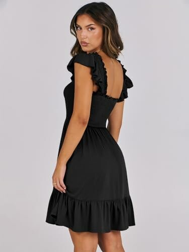 Woman in black dress with ruffled sleeves