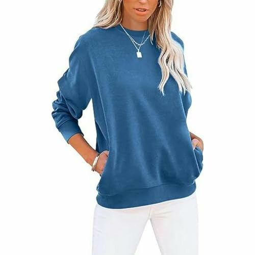 Woman in blue sweatshirt with hands in pockets