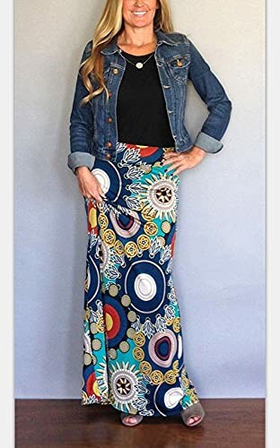 Woman wearing a white crop top and colorful patterned maxi skirt.