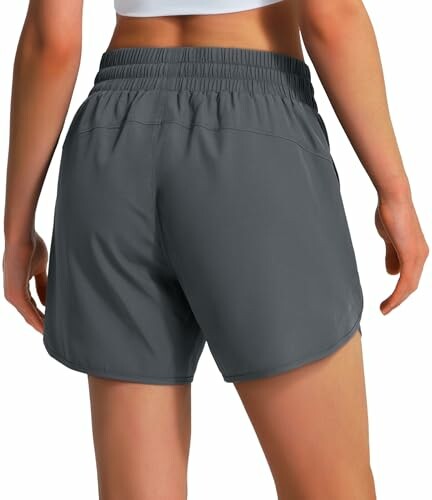 Woman in gray athletic shorts viewed from the back