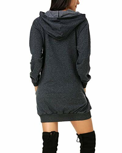 Back view of a woman wearing a dark hooded dress and knee-high boots.