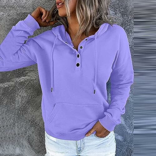 Woman wearing a purple hoodie with a hood and buttons.