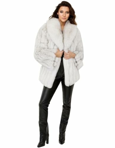 Woman wearing a white fur coat and black pants.