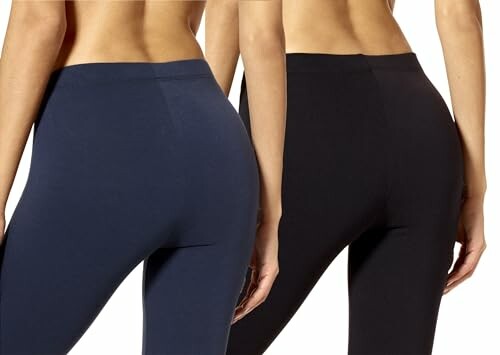 Two women wearing navy and black leggings from the back.