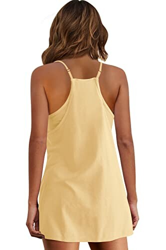 Back view of a woman wearing a yellow sundress.